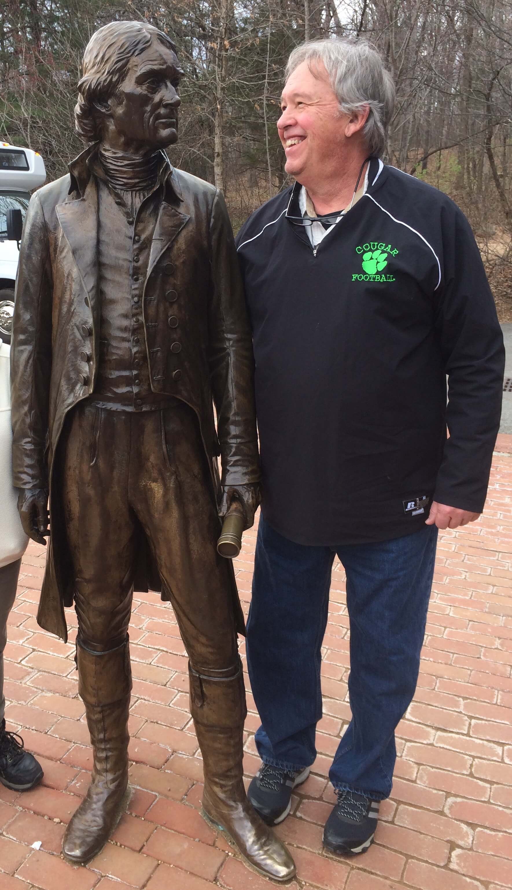 Portrait: John Stallings appears standing to the right of a statue of Thomas Jefferson.